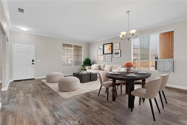 dining space featuring baseboards, dark wood finished floors, visible vents, and crown molding