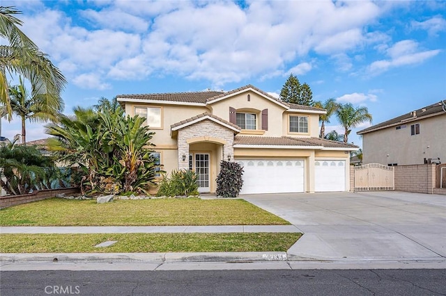 mediterranean / spanish home featuring a garage and a front lawn