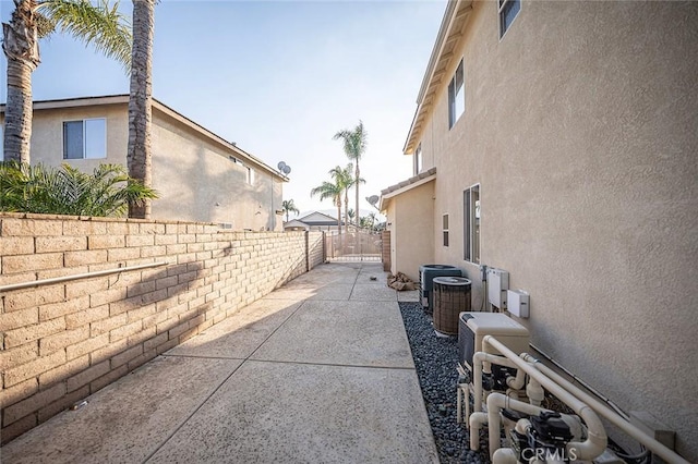 view of home's exterior with a patio and central AC unit