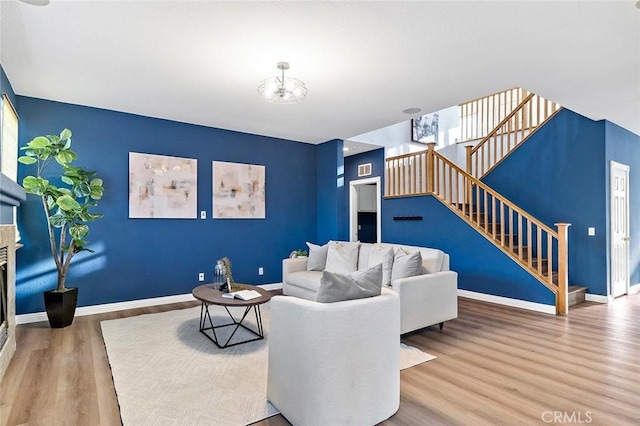 living room with hardwood / wood-style floors and an inviting chandelier