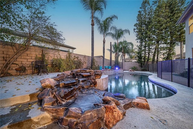 view of pool at dusk