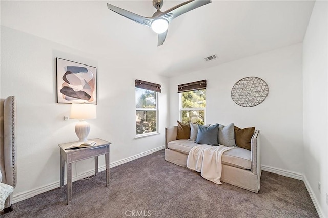 sitting room featuring dark colored carpet and ceiling fan