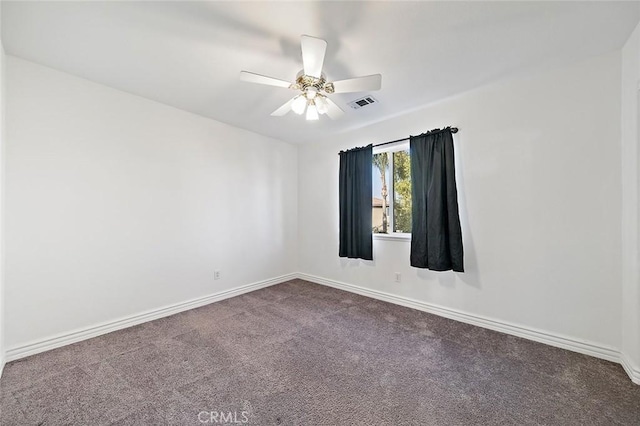 carpeted spare room with ceiling fan