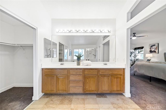 bathroom with vanity, an enclosed shower, and ceiling fan