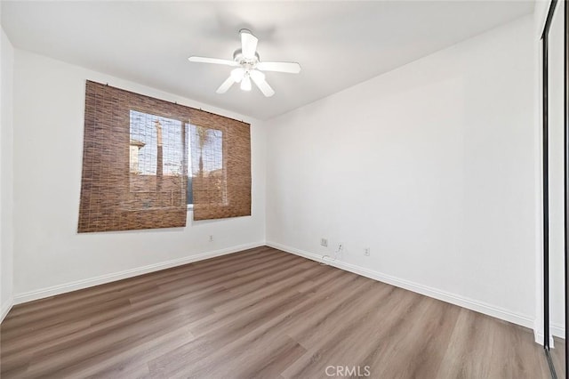 spare room with wood-type flooring and ceiling fan