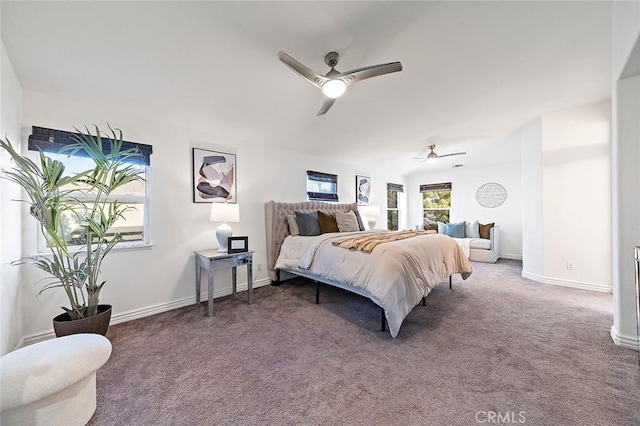 carpeted bedroom featuring multiple windows and ceiling fan