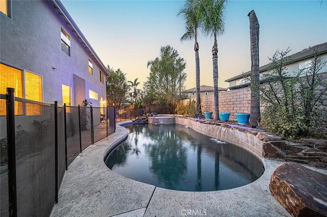 view of pool at dusk