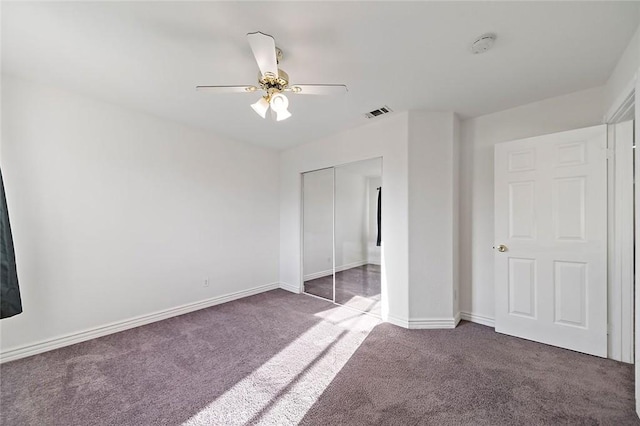 unfurnished bedroom featuring carpet, ceiling fan, and a closet