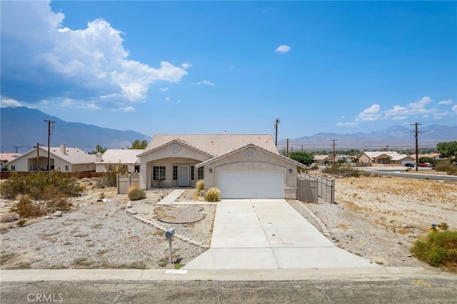 view of front facade featuring a mountain view and a garage