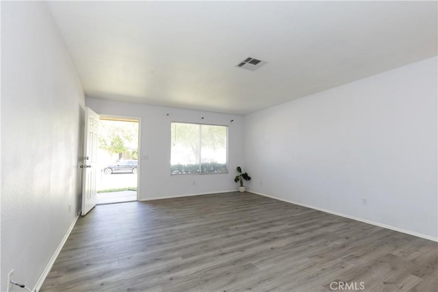 spare room with dark wood-type flooring