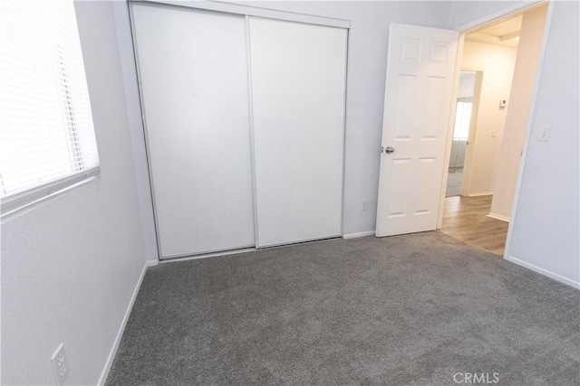 unfurnished bedroom featuring a closet and carpet