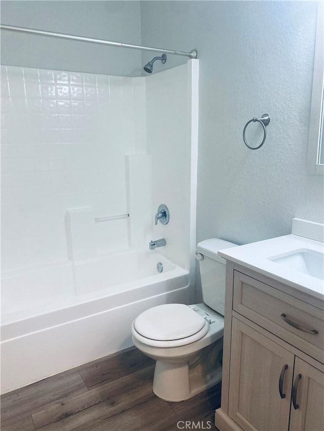 full bathroom with vanity, toilet, hardwood / wood-style floors, and  shower combination