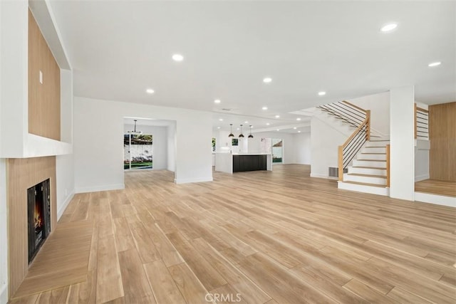 unfurnished living room with light hardwood / wood-style flooring