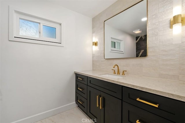 bathroom featuring vanity and decorative backsplash