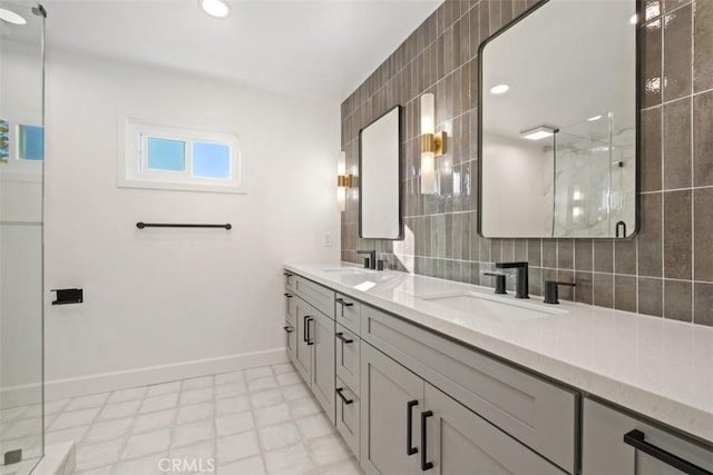 bathroom featuring tasteful backsplash, vanity, a shower with shower door, and tile walls