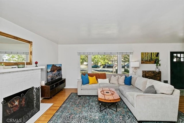 living room featuring a fireplace and light hardwood / wood-style flooring