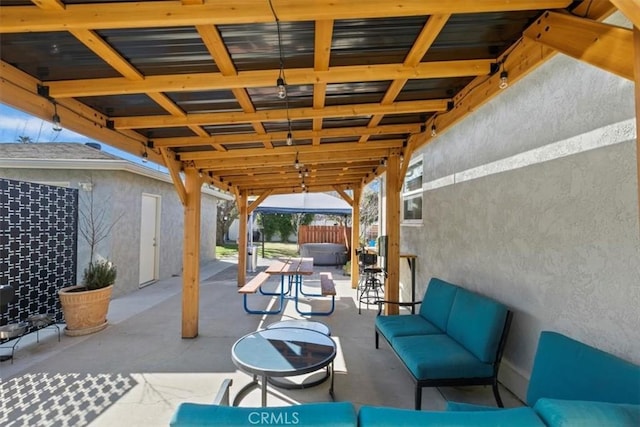 view of patio with outdoor lounge area and a hot tub