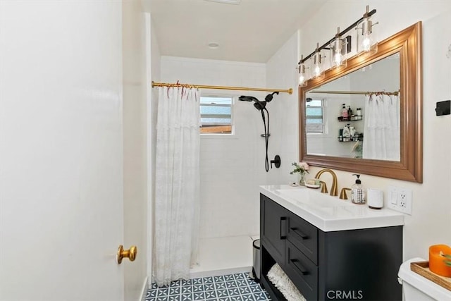 bathroom with vanity, toilet, and walk in shower