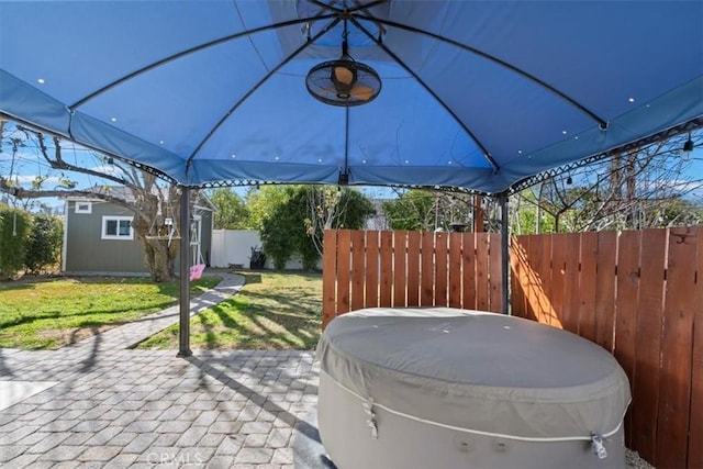 view of patio / terrace featuring a gazebo and a storage unit