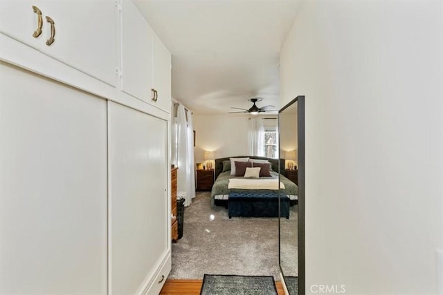 bedroom featuring light colored carpet and a closet