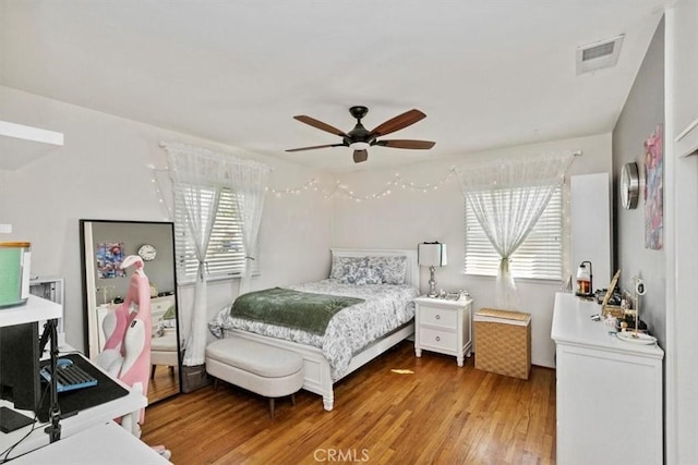 bedroom with ceiling fan and wood-type flooring