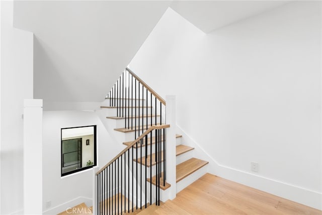 staircase featuring wood-type flooring