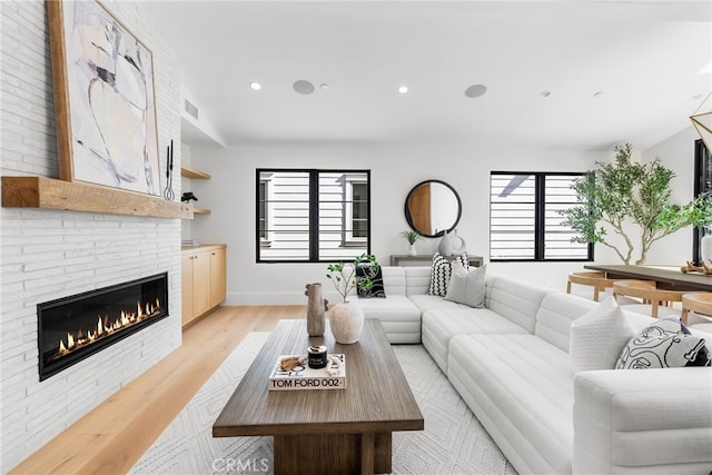 living room featuring a fireplace and light hardwood / wood-style flooring