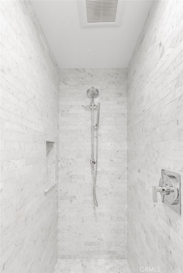 bathroom with tiled shower