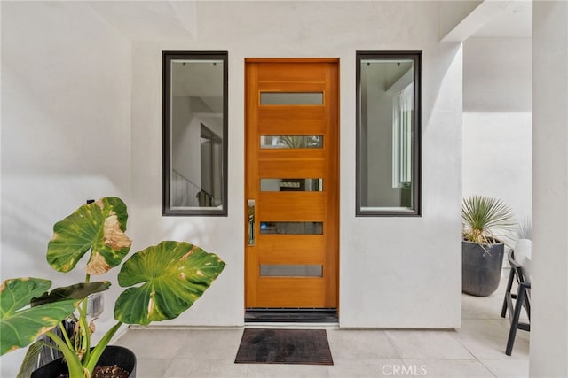 entrance to property with stucco siding