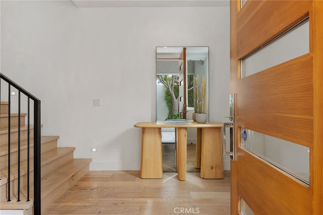 stairs with baseboards and wood finished floors