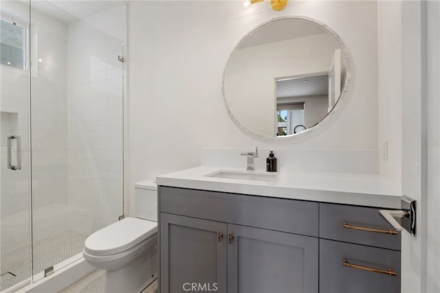 full bathroom with a shower stall, vanity, and toilet