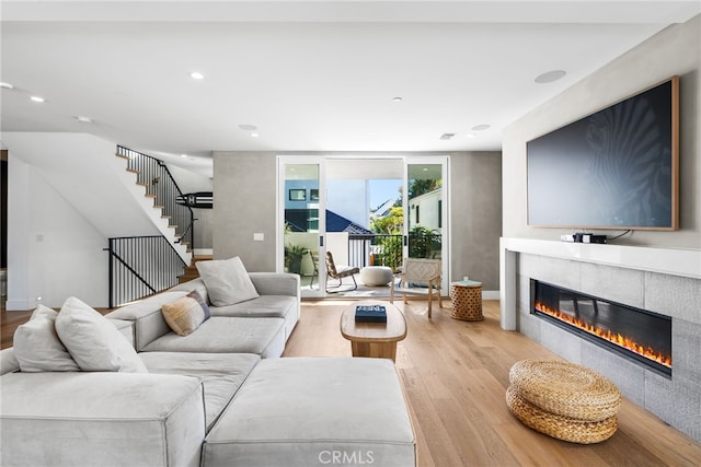 living room featuring a fireplace and light hardwood / wood-style floors