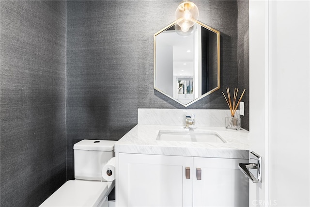 bathroom featuring toilet and vanity