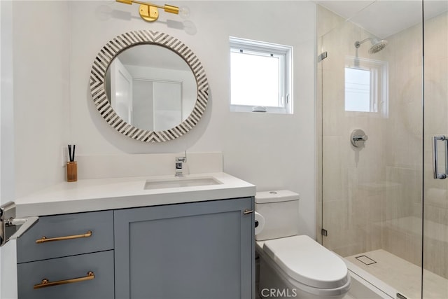 bathroom with toilet, a stall shower, plenty of natural light, and vanity