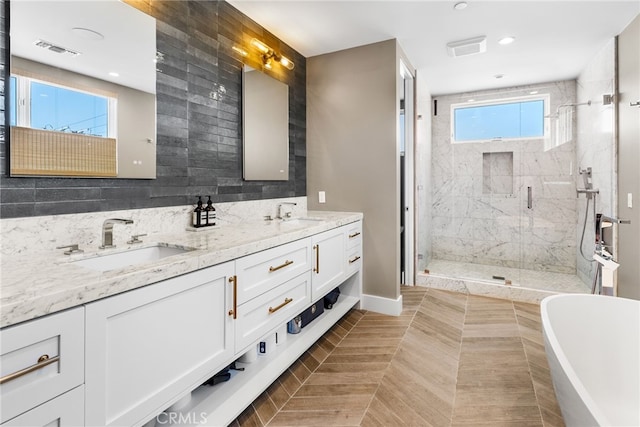 bathroom featuring vanity and shower with separate bathtub