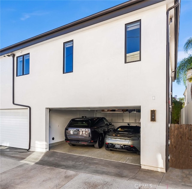 view of front of property featuring a garage and stucco siding