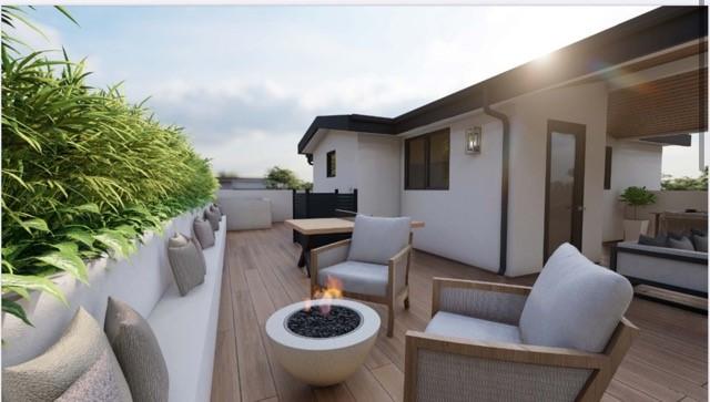 deck featuring an outdoor living space with a fire pit