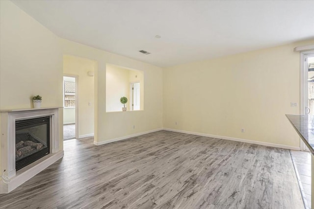 unfurnished living room featuring hardwood / wood-style floors