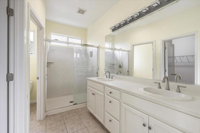 bathroom featuring walk in shower, tile patterned floors, toilet, and vanity