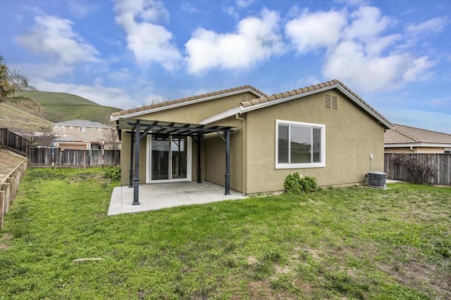 back of house featuring a patio, a lawn, central air condition unit, and a pergola