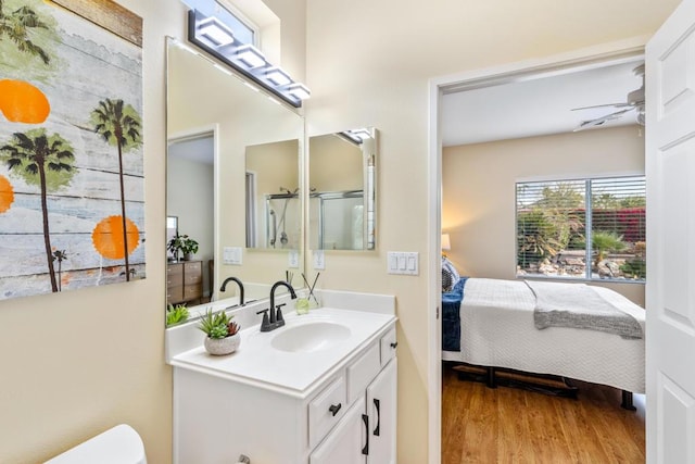 bathroom with ceiling fan, wood-type flooring, and vanity