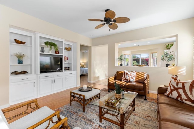 living room with ceiling fan and light hardwood / wood-style floors