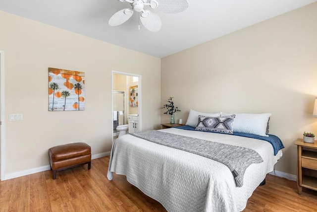 bedroom with ceiling fan, wood-type flooring, and ensuite bath