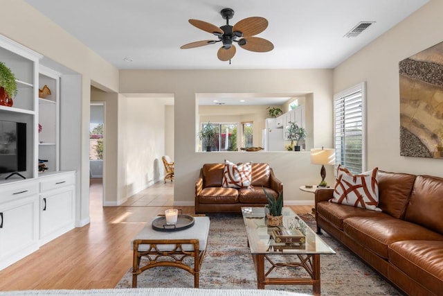 living room featuring ceiling fan and light hardwood / wood-style flooring