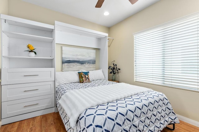 bedroom with wood-type flooring and ceiling fan