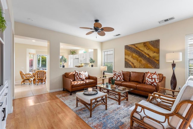 living room featuring ceiling fan and light wood-type flooring