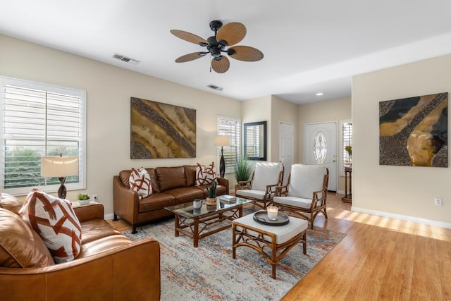 living room with ceiling fan and light wood-type flooring