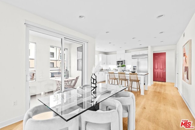 dining space featuring light wood-type flooring