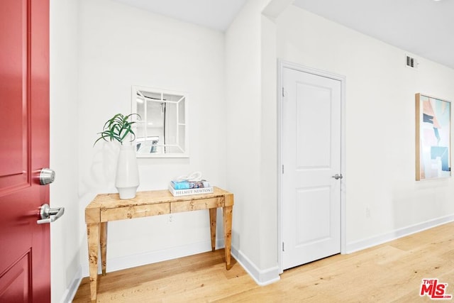 corridor featuring hardwood / wood-style floors