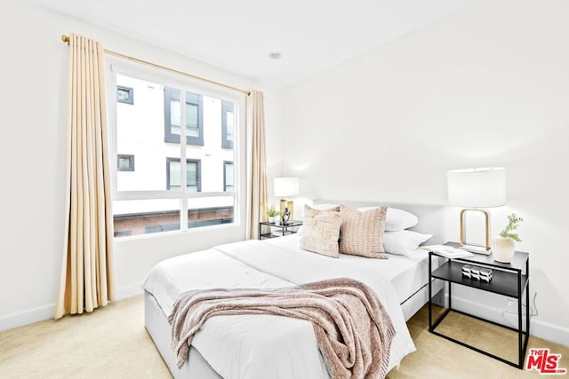 bedroom with light colored carpet